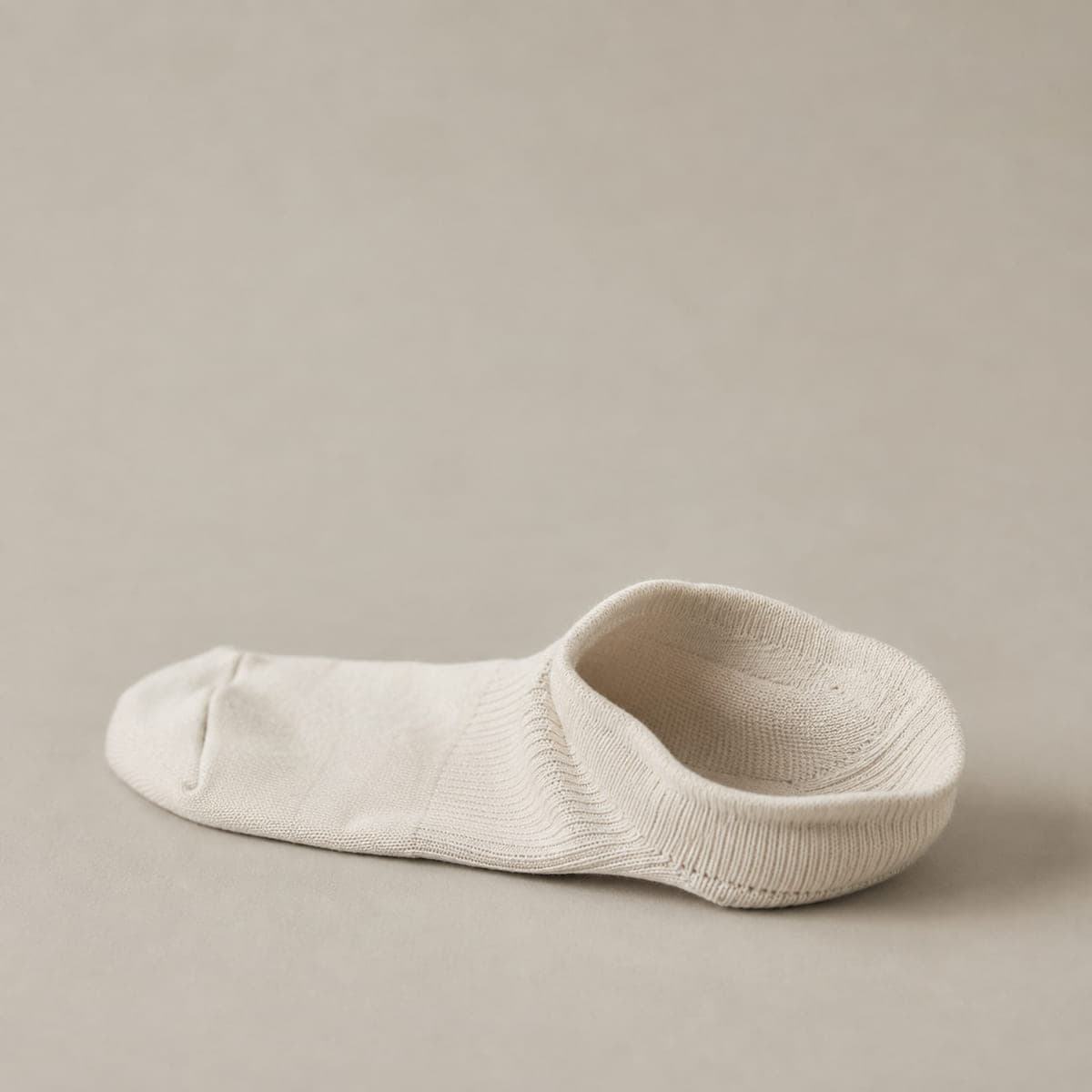 A sock with the heel propped open, showing a deep cup-shaped heel pocket.