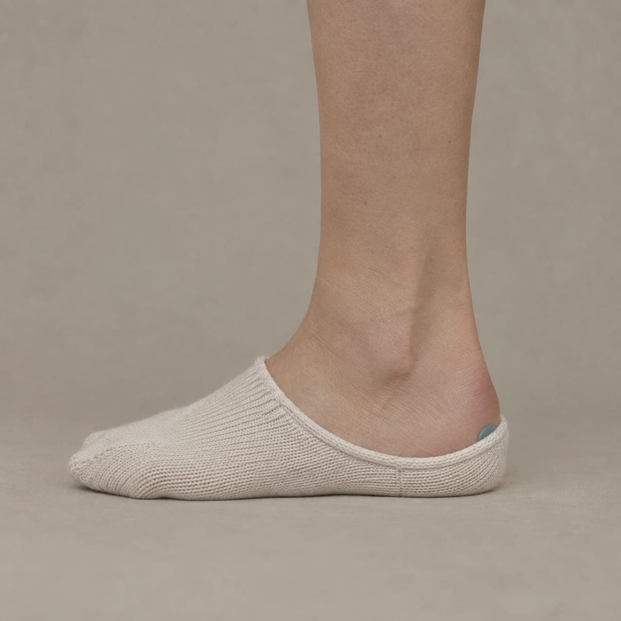 Deep 22 worn on a foot, seen from the side, with the cuff edge visible above the heel.