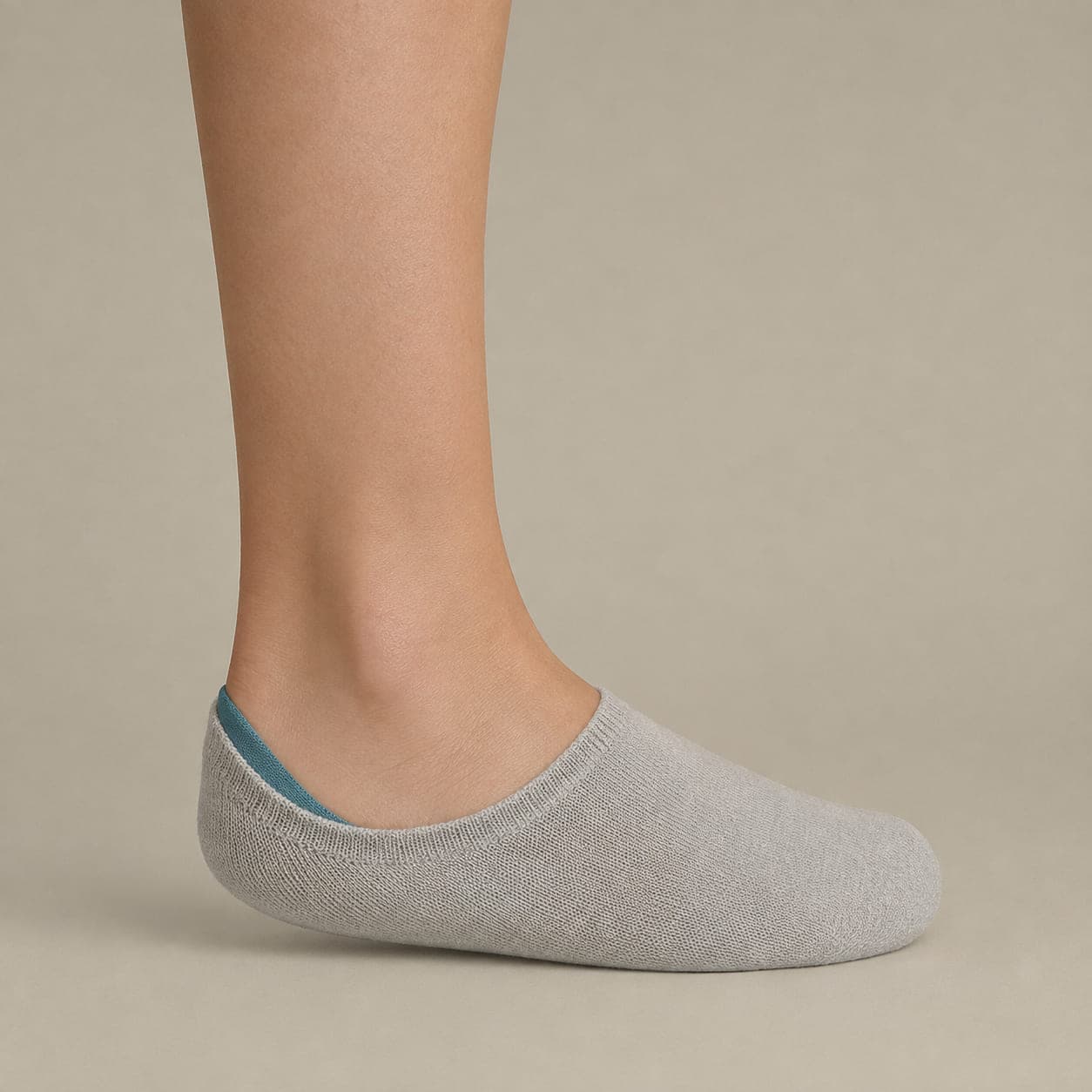 Deep 32 Wide worn on a foot, seen from the side, with the cuff edge visible above the heel.