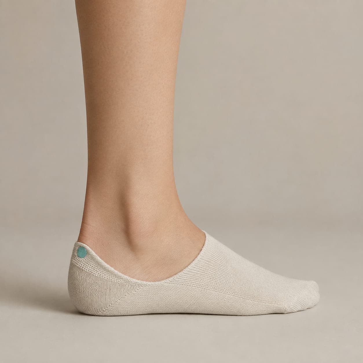 Hidden 34 worn on a foot, seen from the side, with the cuff edge visible above the heel.