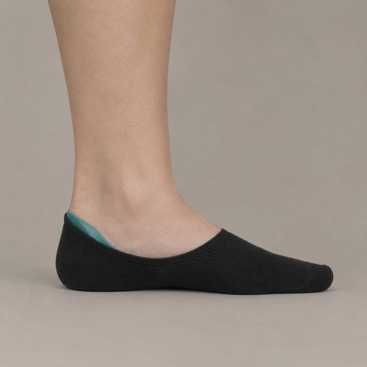 Hidden 38 worn on a foot, seen from the side, with the cuff edge visible above the heel.
