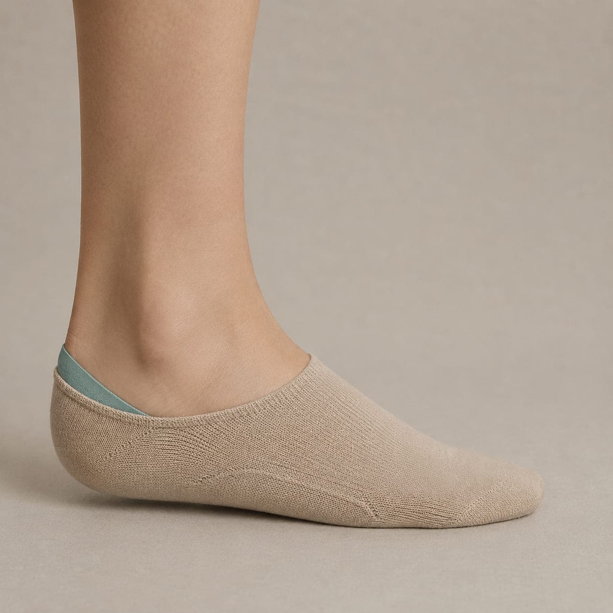 Hidden 38 Cushion worn on a foot, seen from the side, with the cuff edge visible above the heel.