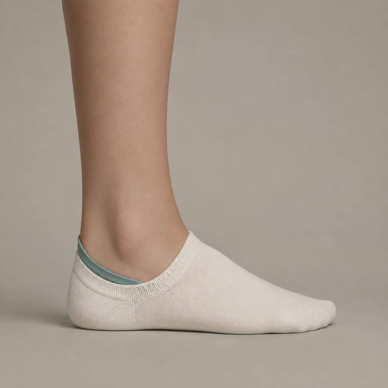 Hidden 38 Cotton worn on a foot, seen from the side, with the cuff edge visible above the heel.