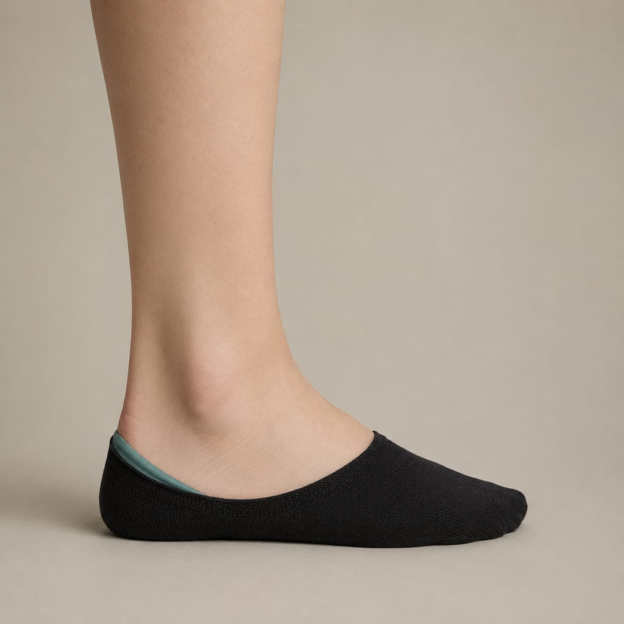 Hidden Premium worn on a foot, seen from the side, with the cuff edge visible above the heel.