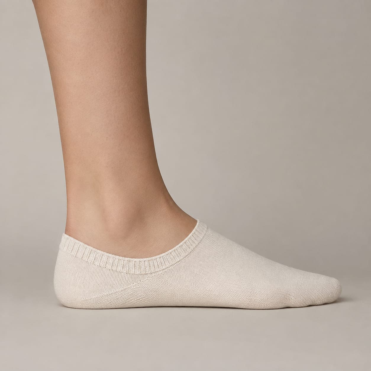 Band 34 worn on a foot, seen from the side, with the cuff edge visible above the heel.