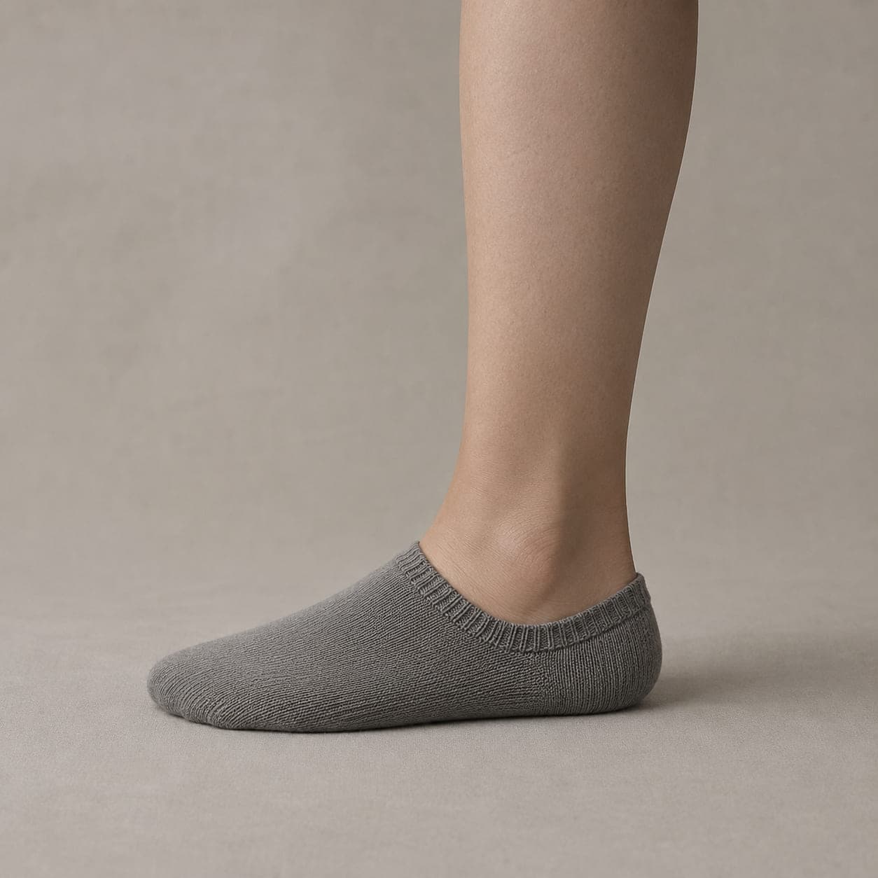 Band 42 Wide worn on a foot, seen from the side, with the cuff edge visible above the heel.