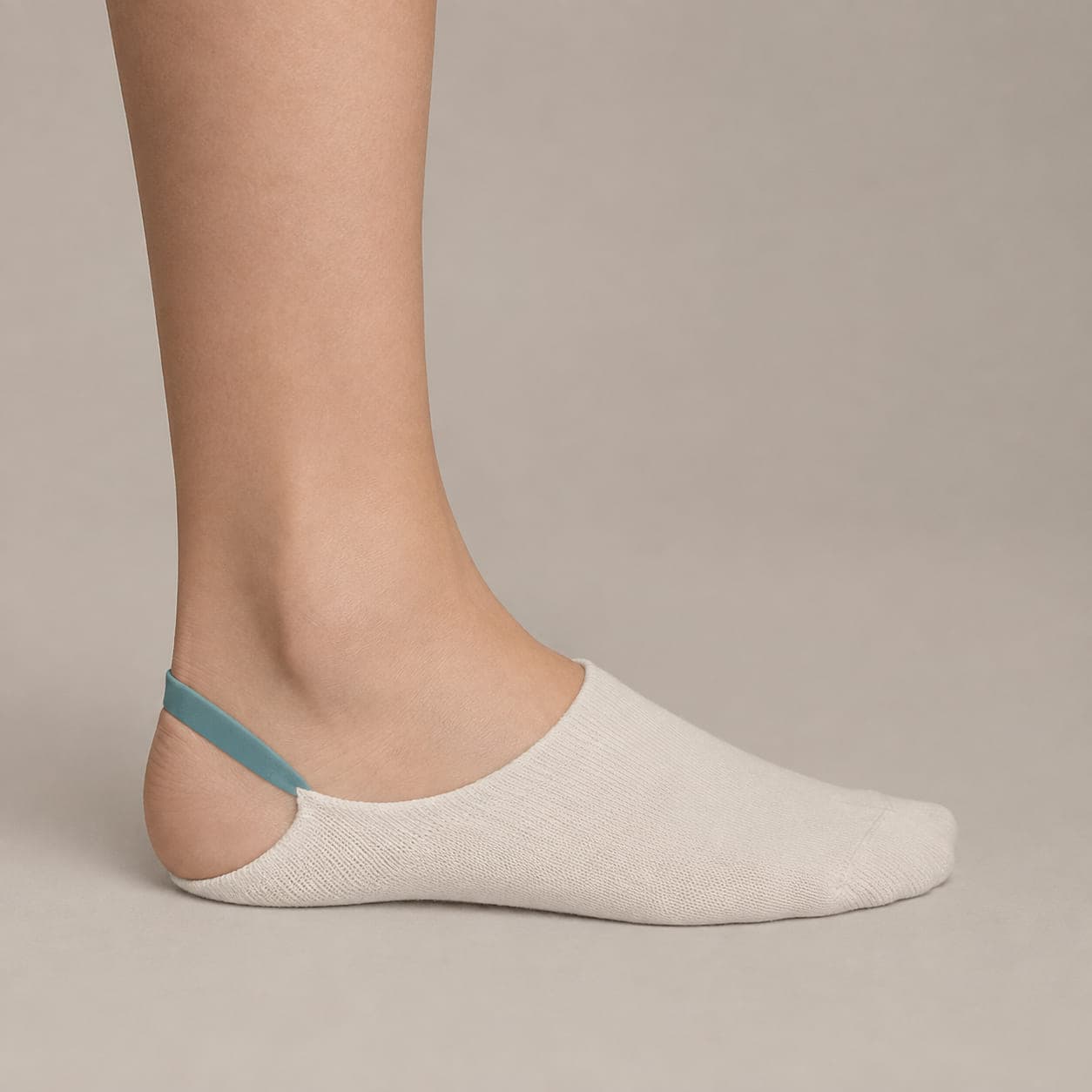 Grip Arc 5 worn on a foot, seen from the side, with the cuff edge visible above the heel.