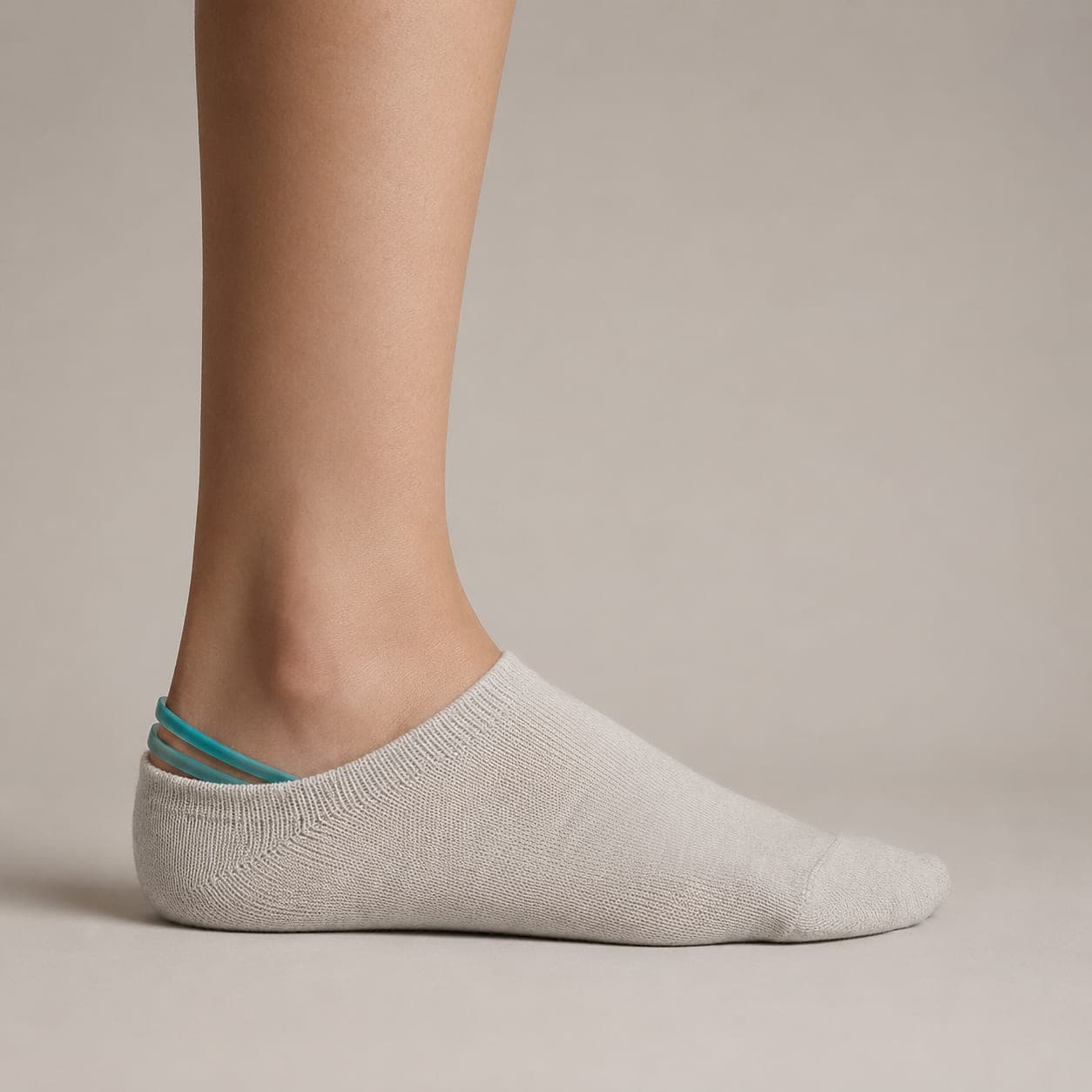 Grip Double worn on a foot, seen from the side, with the cuff edge visible above the heel.