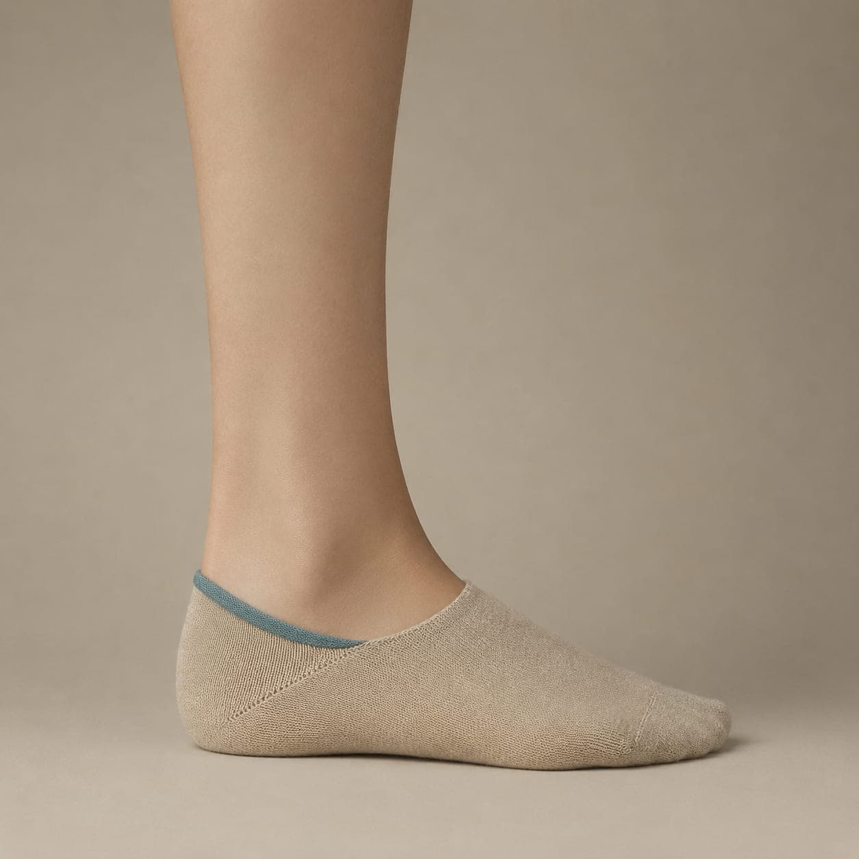 Grip Full Ring worn on a foot, seen from the side, with the cuff edge visible above the heel.