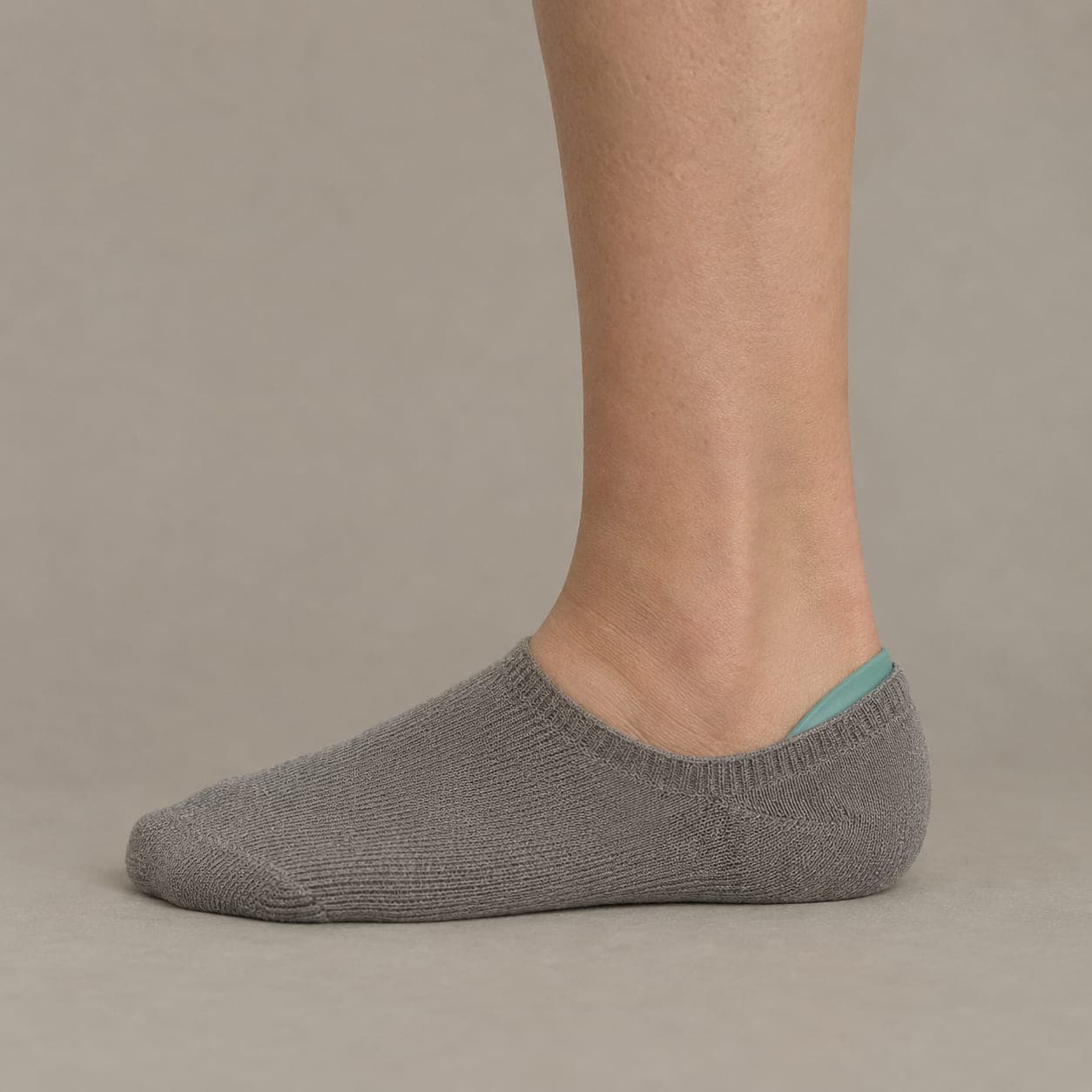 Grip Arc Wide worn on a foot, seen from the side, with the cuff edge visible above the heel.